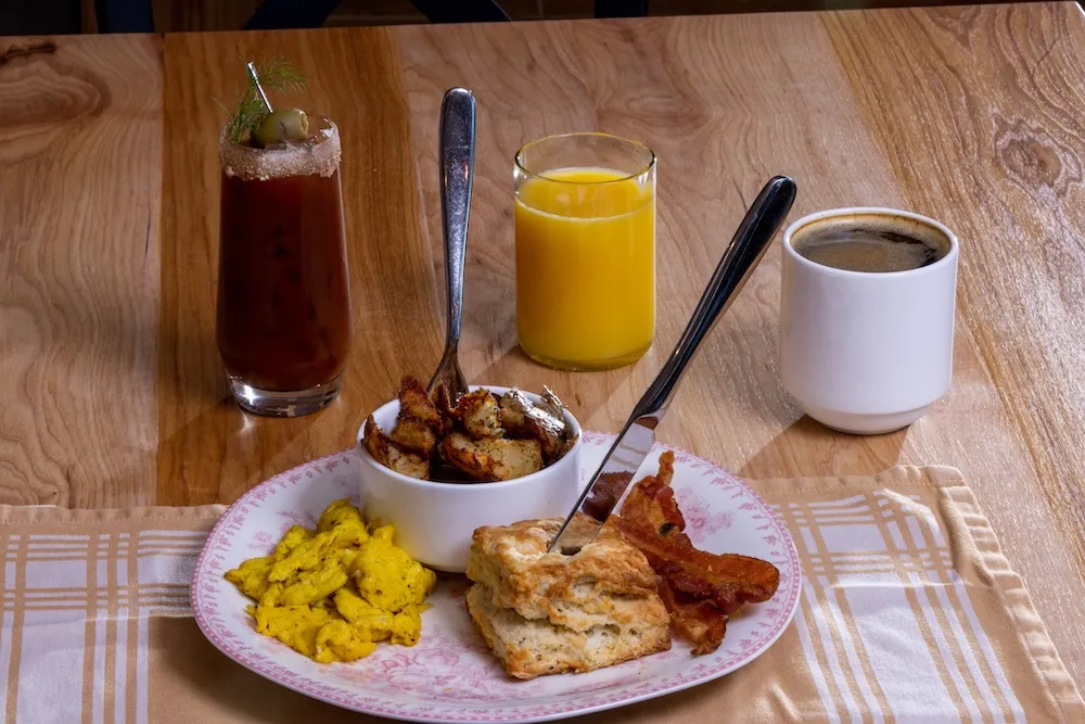 plate of biscuit, bacon and eggs